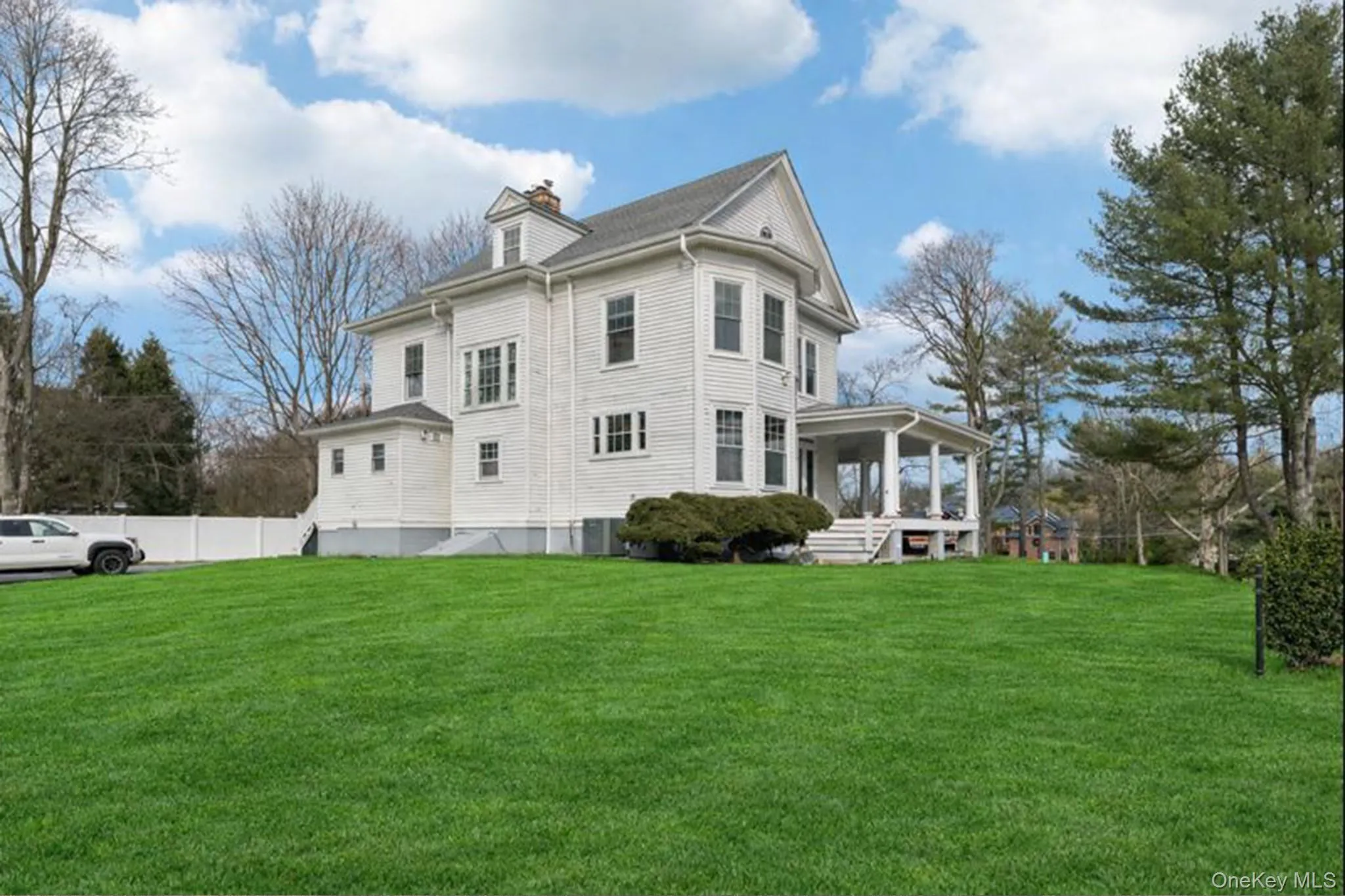 Rear view of property with a yard, a chimney, and a sunroom Rear view of property with a yard, a chimney, and a sunroom