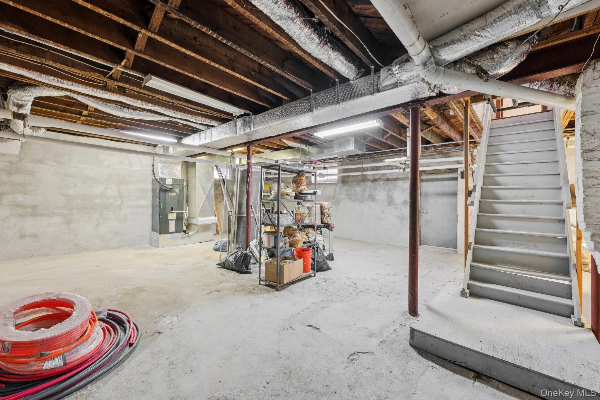 Unfinished below grade area featuring stairway Unfinished below grade area featuring stairway