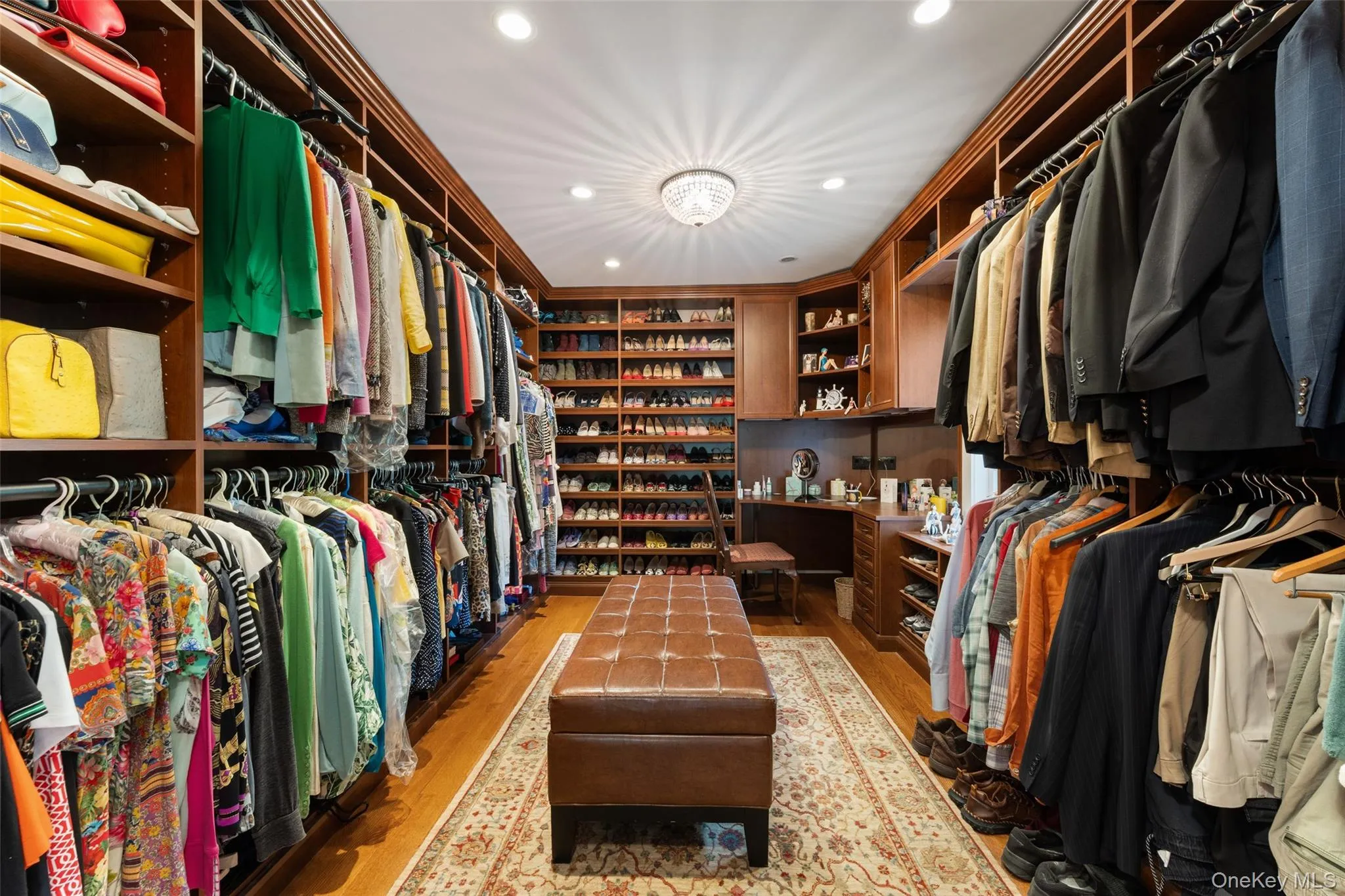 Primary walk in closet with custom built in cabinetry Primary walk in closet with custom built in cabinetry