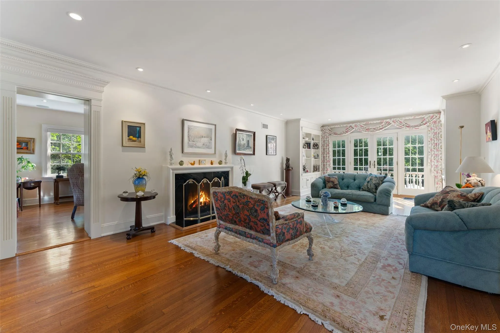 Living room with wood burning fireplace and french doors to patio Living room with wood burning fireplace and french doors to patio