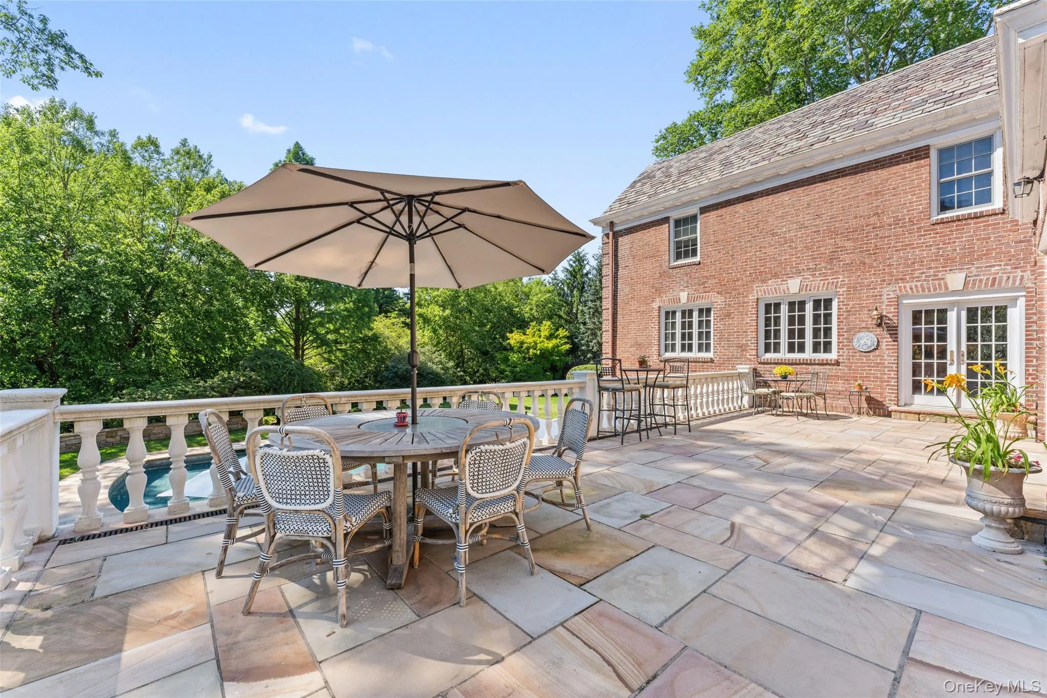 Patio off kitchen area overlooking pool and grounds Patio off kitchen area overlooking pool and grounds
