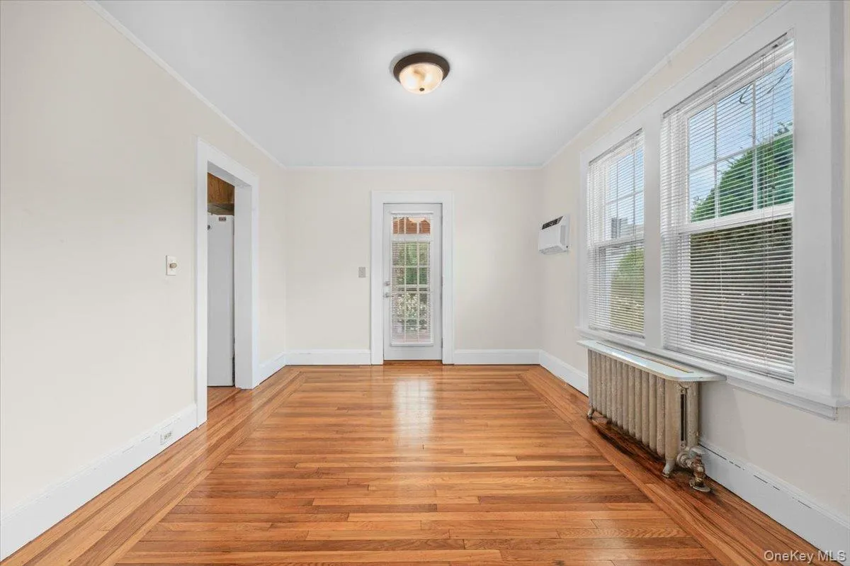 Bright and sunny dining area leads to rear screened in porch. Air conditioner in the wall. Bright and sunny dining area leads to rear screened in porch. Air conditioner in the wall.