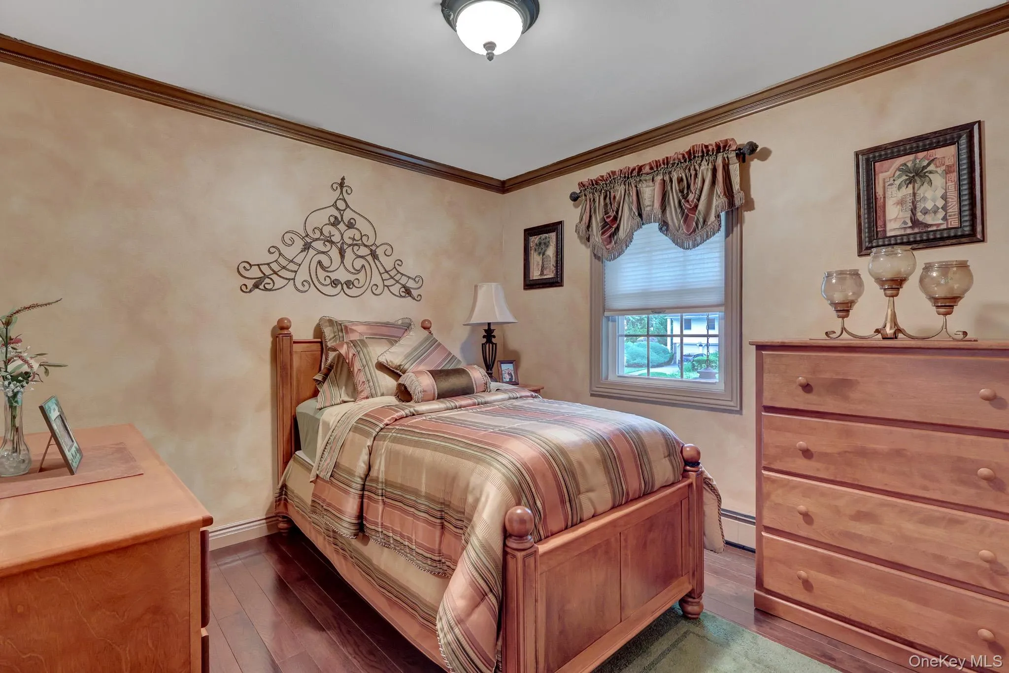 Rich wood-finish flooring complements the room's warm wall tones Rich wood-finish flooring complements the room's warm wall tones