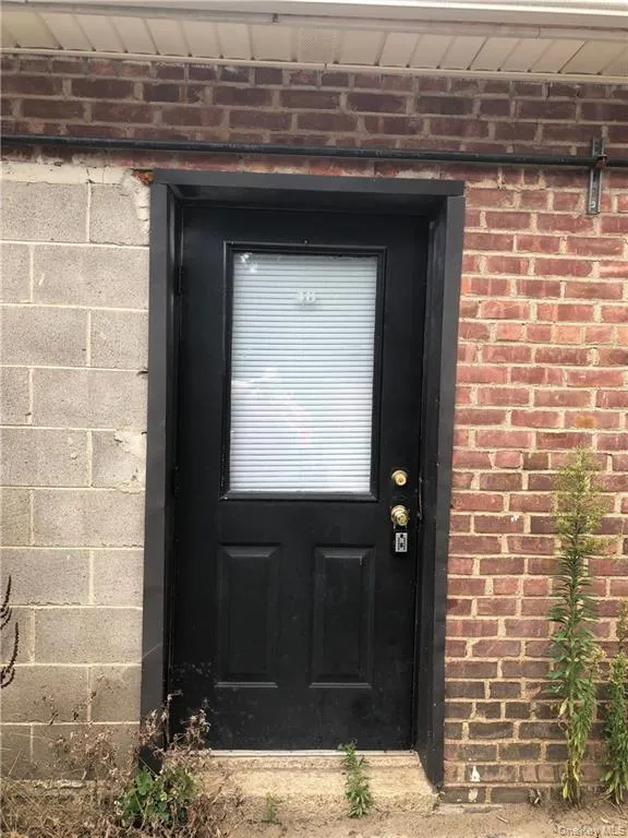 View of exterior entry with brick siding View of exterior entry with brick siding