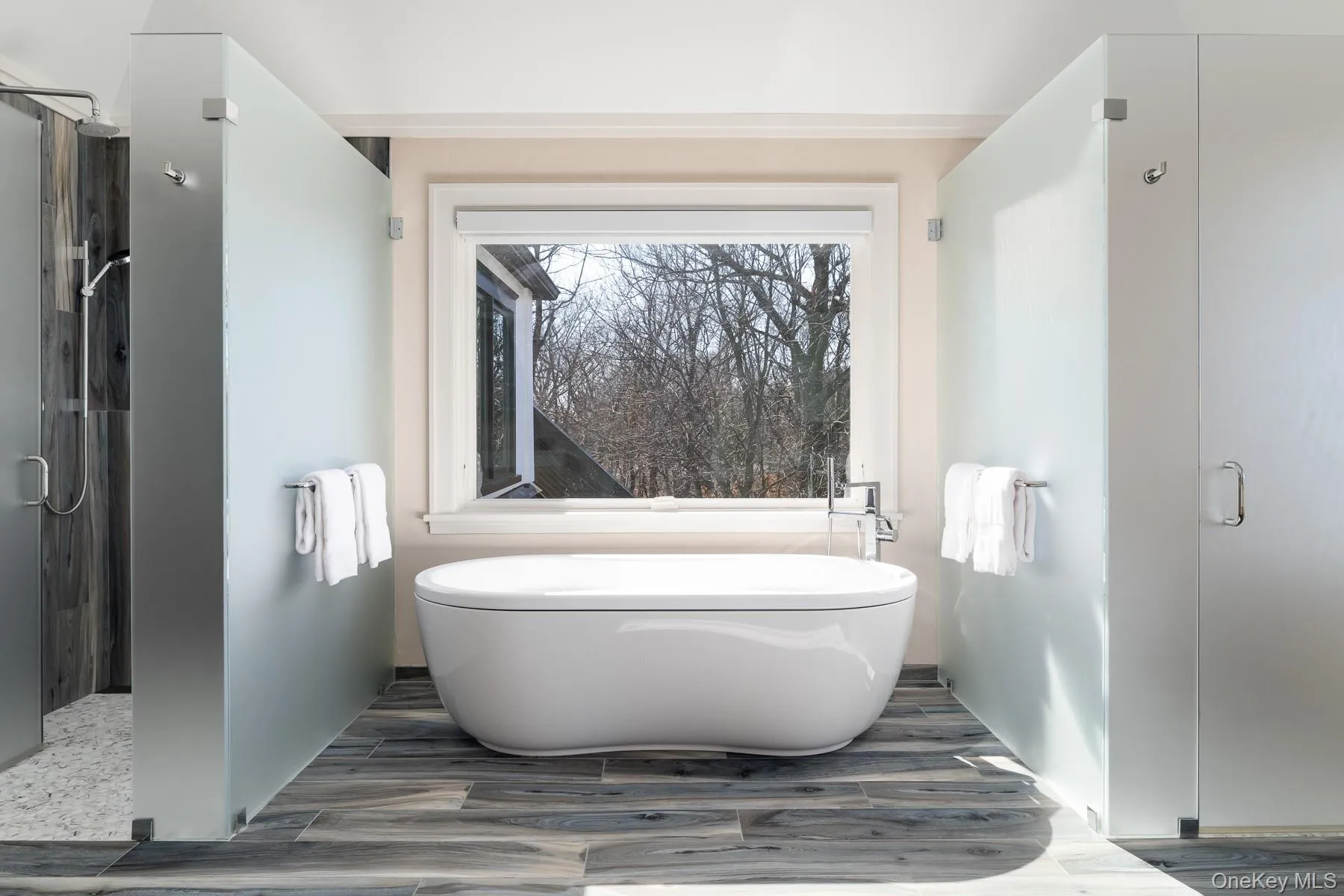 Primary bathroom with soaking tub and radiant heated floors. Primary bathroom with soaking tub and radiant heated floors.