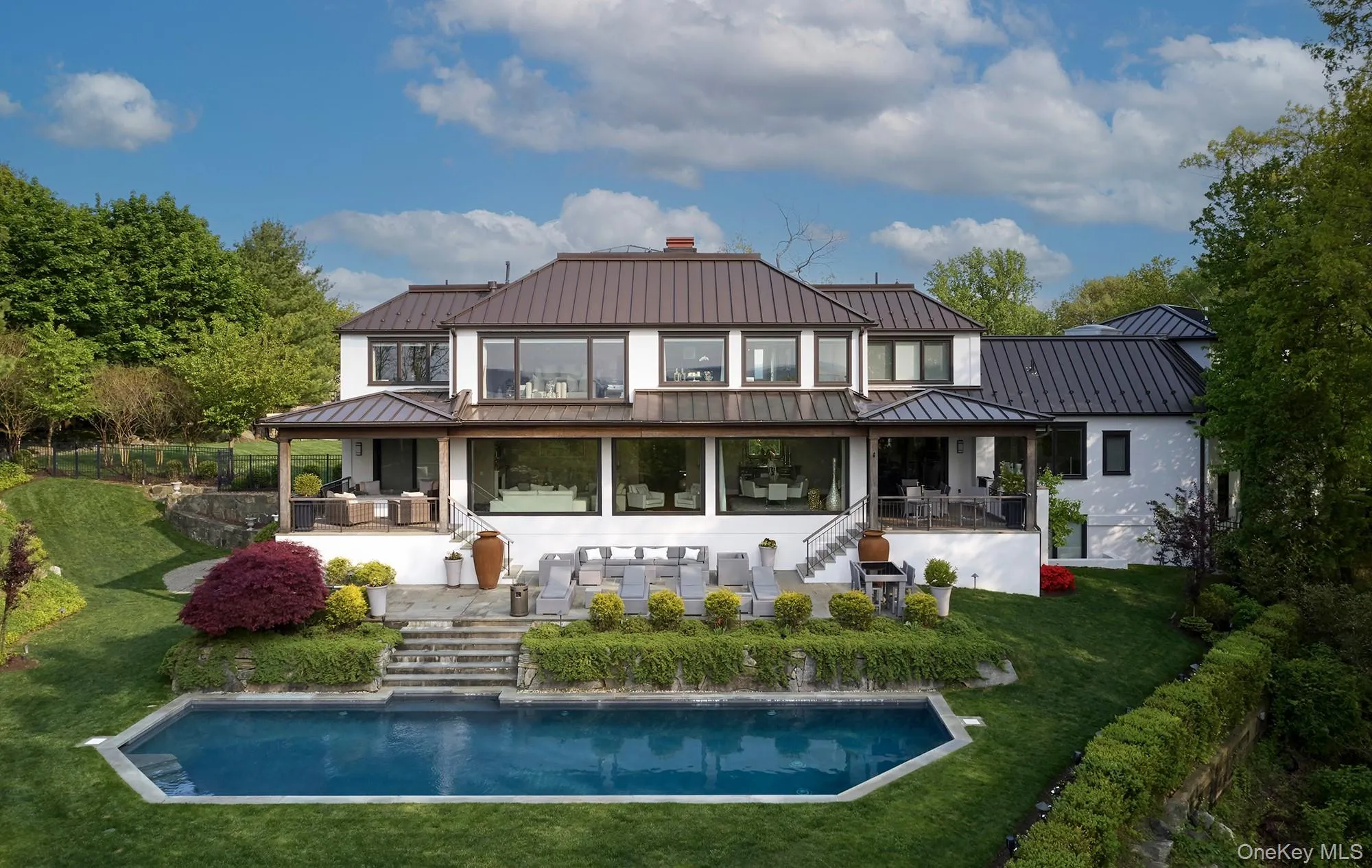 Rear view of house with heated salt water pool and multiple outdoor living areas. Rear view of house with heated salt water pool and multiple outdoor living areas.