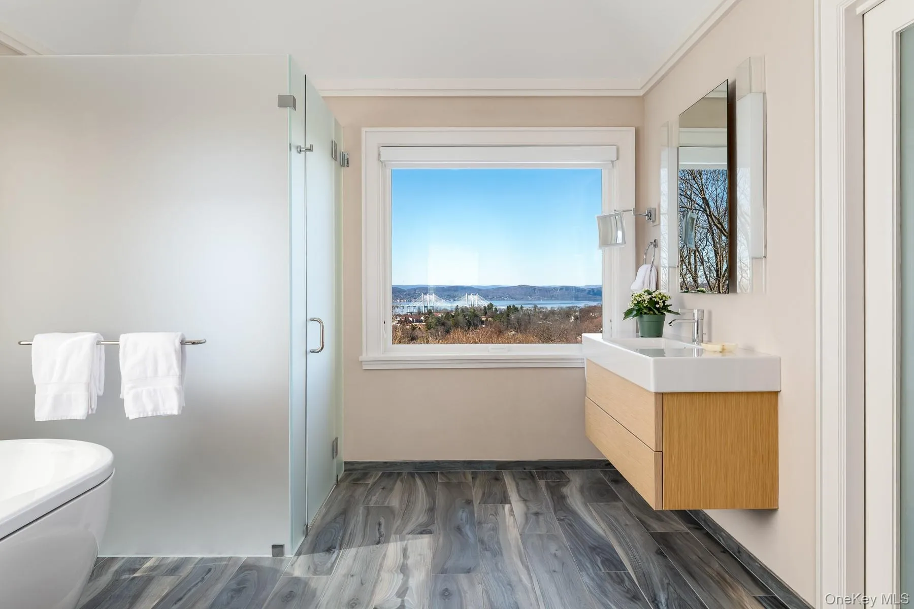 Spacious primary bathroom with Duravit vanities and Dornbracht fixtures. Spacious primary bathroom with Duravit vanities and Dornbracht fixtures.
