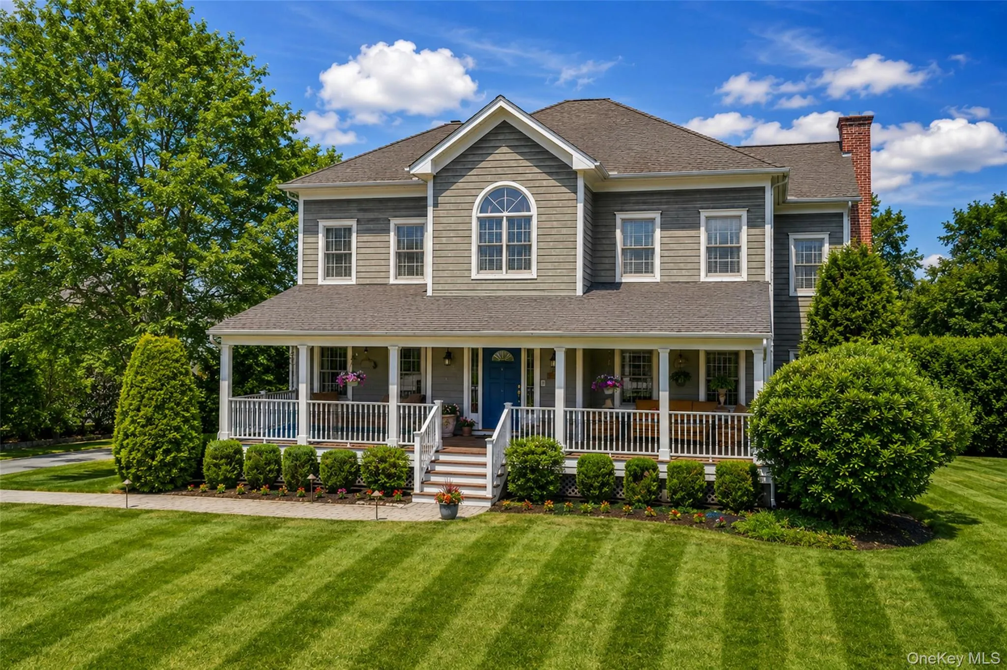 Expansive colonial-style residence featuring a broad front porch Expansive colonial-style residence featuring a broad front porch