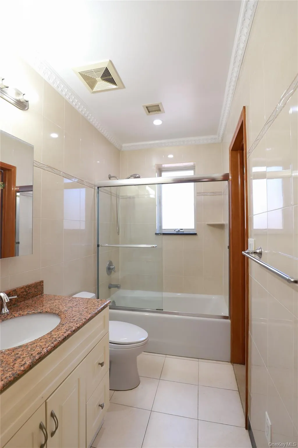Bathroom with a full bathtub featuring a sliding glass enclosure Bathroom with a full bathtub featuring a sliding glass enclosure