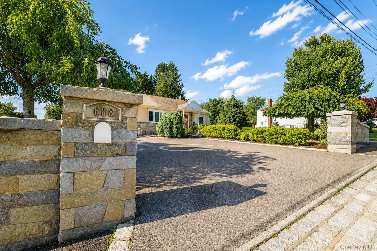 Belgium block lined driveway with a center medallion & stone entrance walls welcome you home! Belgium block lined driveway with a center medallion & stone entrance walls welcome you home!