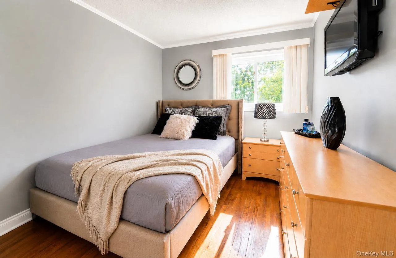 2nd Bedroom - Natural light streams in enhancing the warmth of the hardwood floors 2nd Bedroom - Natural light streams in enhancing the warmth of the hardwood floors