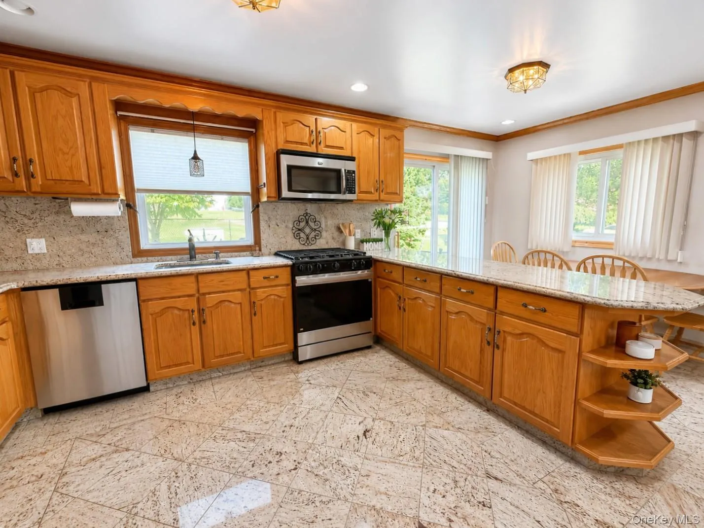 An open-concept kitchen with granite features & stainless steel appliances An open-concept kitchen with granite features & stainless steel appliances