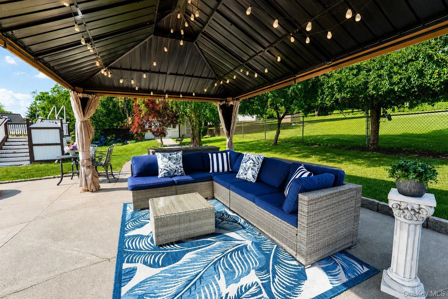 Covered outdoor patio area with string lighting Covered outdoor patio area with string lighting