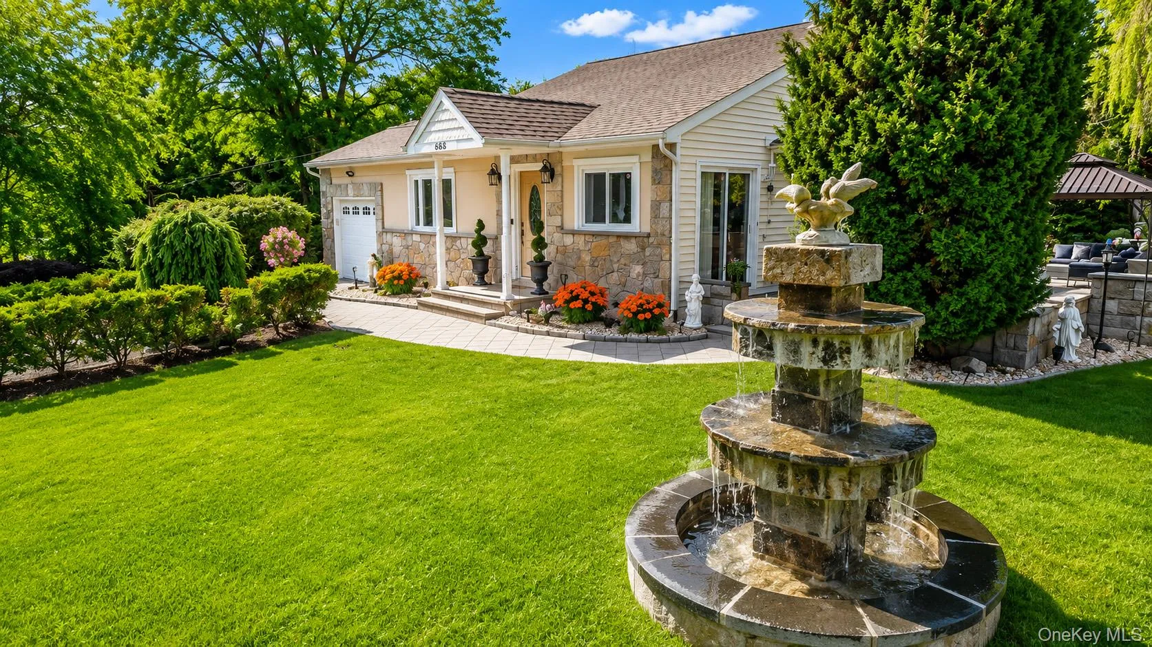 Flowering gardens, custom stone accents and a custom fountain welcome you home! Flowering gardens, custom stone accents and a custom fountain welcome you home!