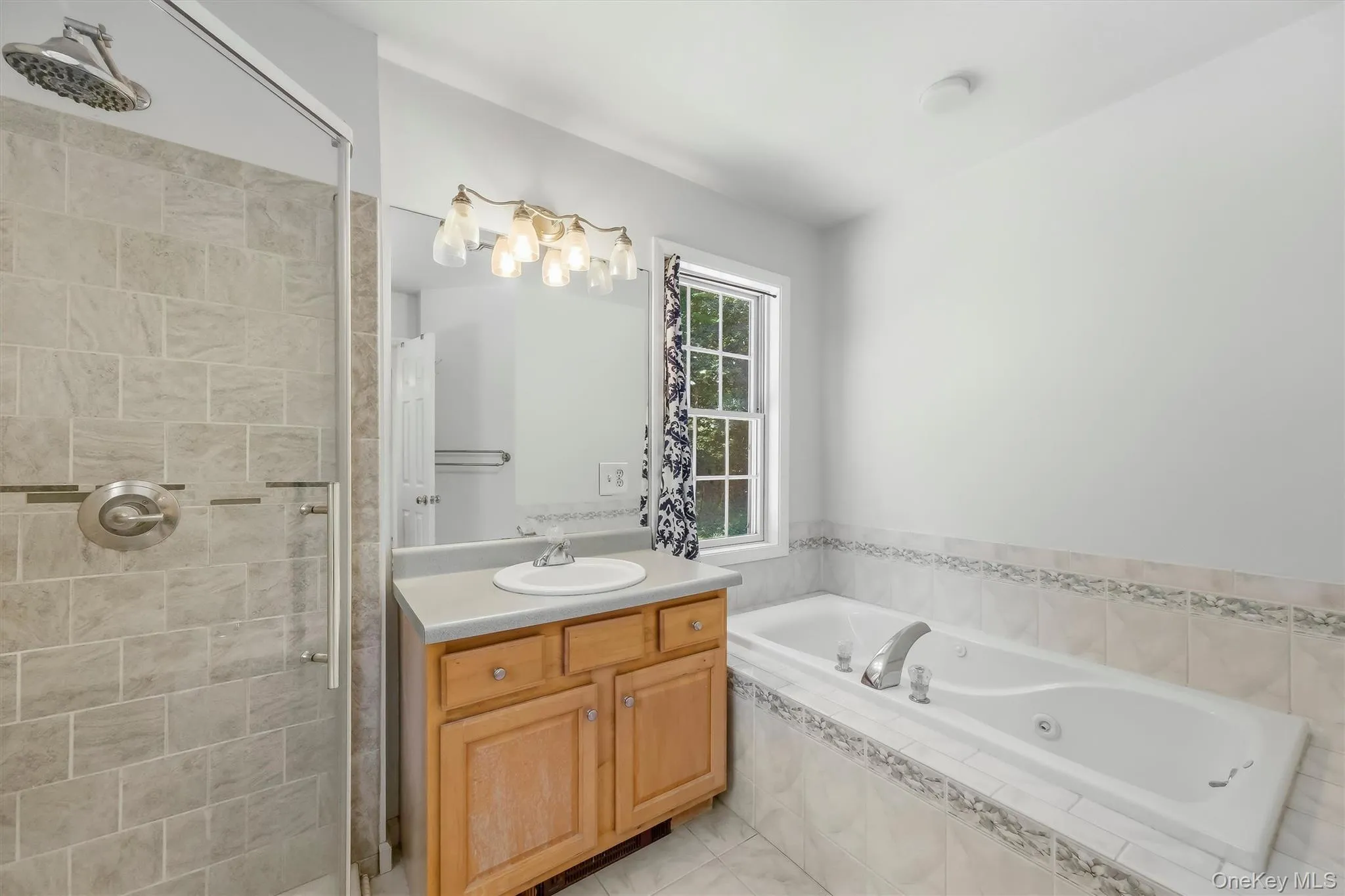 Primary bathroom with double vanity, jacuzzi tub & walk-in shower Primary bathroom with double vanity, jacuzzi tub & walk-in shower
