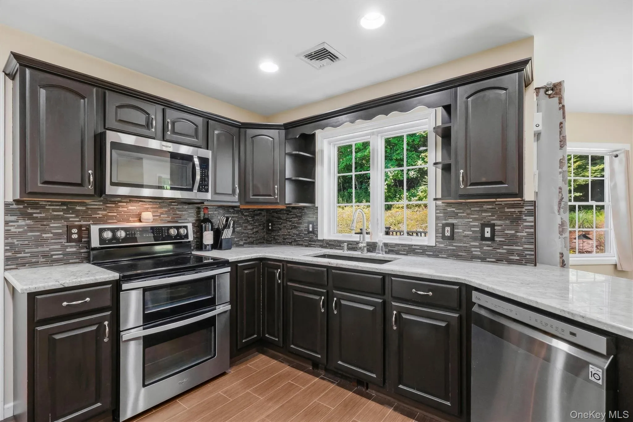 Chef's kitchen with granite countertops & stainless steel appliances Chef's kitchen with granite countertops & stainless steel appliances