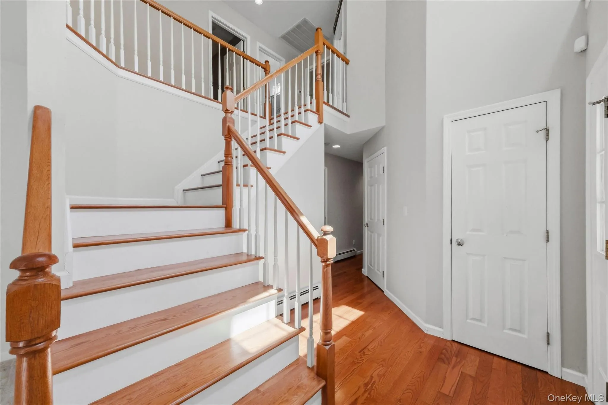 Entry greeted with winded staircase and shining hardwood floors Entry greeted with winded staircase and shining hardwood floors