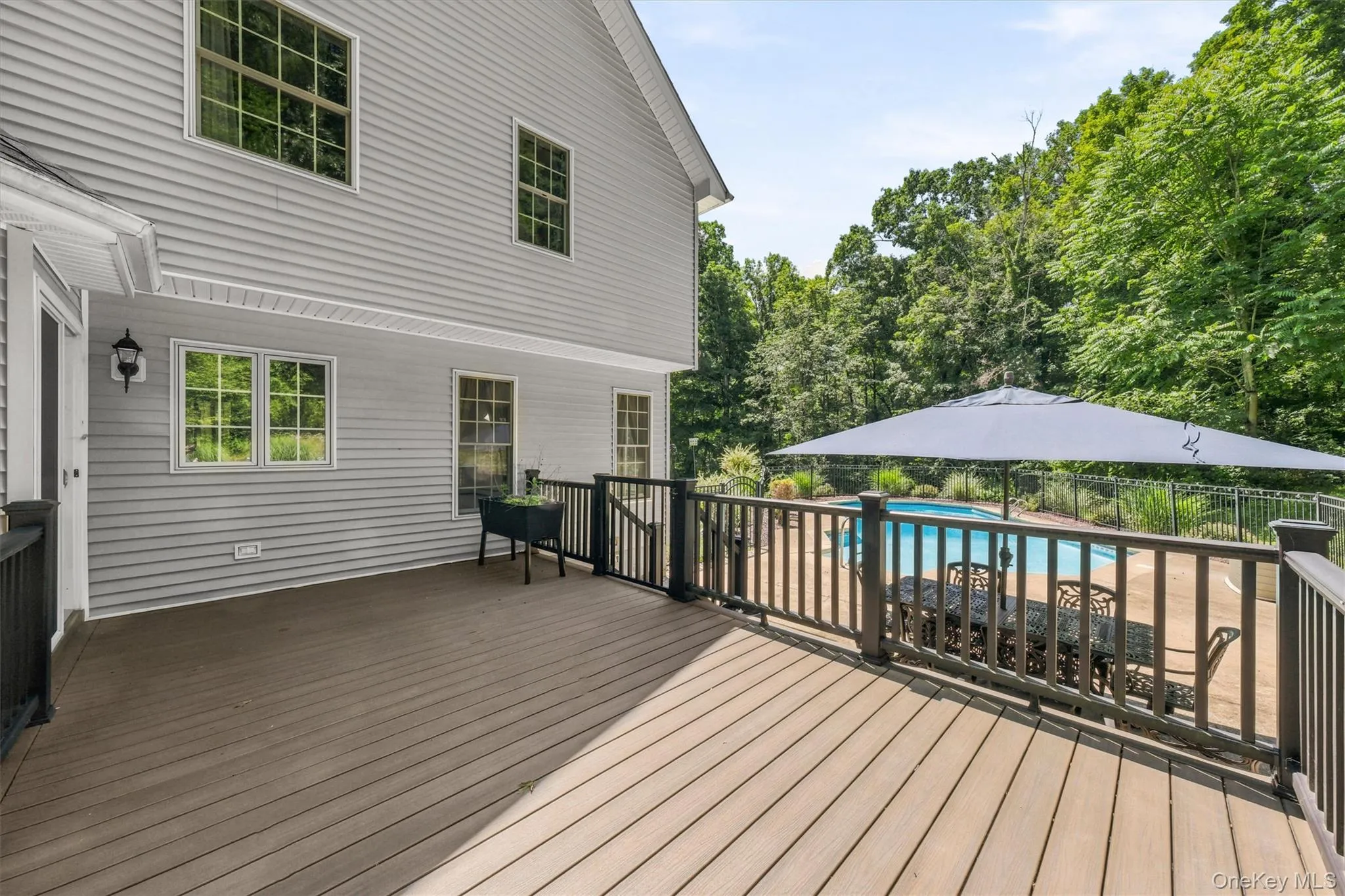 Expansive deck overlooking the inground pool Expansive deck overlooking the inground pool