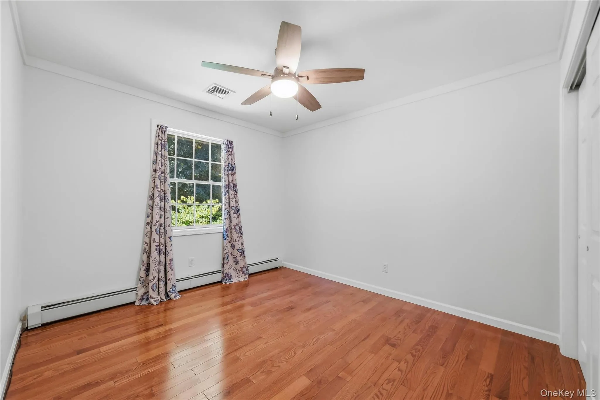 Third Bedroom with gleaming hardwood floors and ample closet space Third Bedroom with gleaming hardwood floors and ample closet space