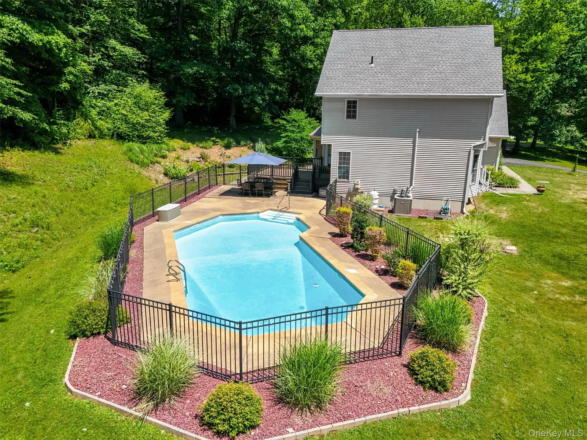 Aerial view of inground saltwater pool, completely fenced in Aerial view of inground saltwater pool, completely fenced in
