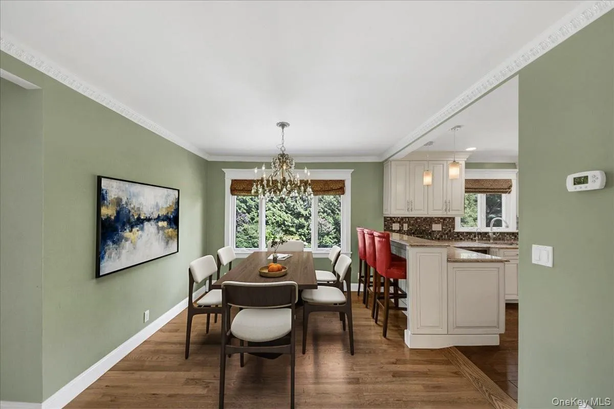 Cozy dining area overlooking expansive backyard. Dining set has been virtually staged. Cozy dining area overlooking expansive backyard. Dining set has been virtually staged.