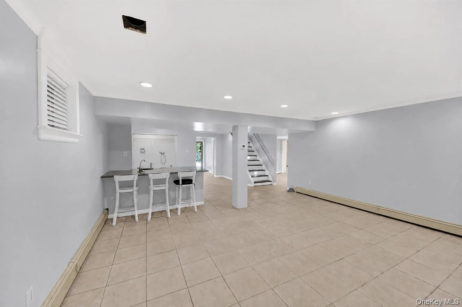 Finished lower level equipped with summer kitchen, bonus room & updated full bathroom Finished lower level equipped with summer kitchen, bonus room & updated full bathroom