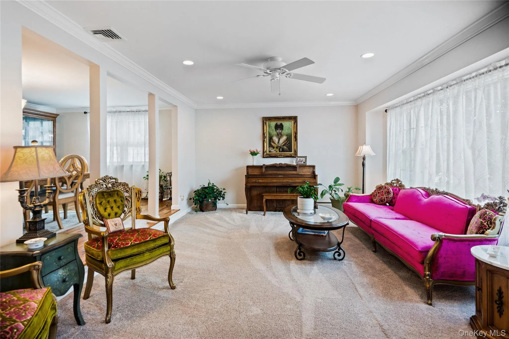 Spacious living area featuring neutral carpet flooring, recessed lighting, and crown molding Spacious living area featuring neutral carpet flooring, recessed lighting, and crown molding