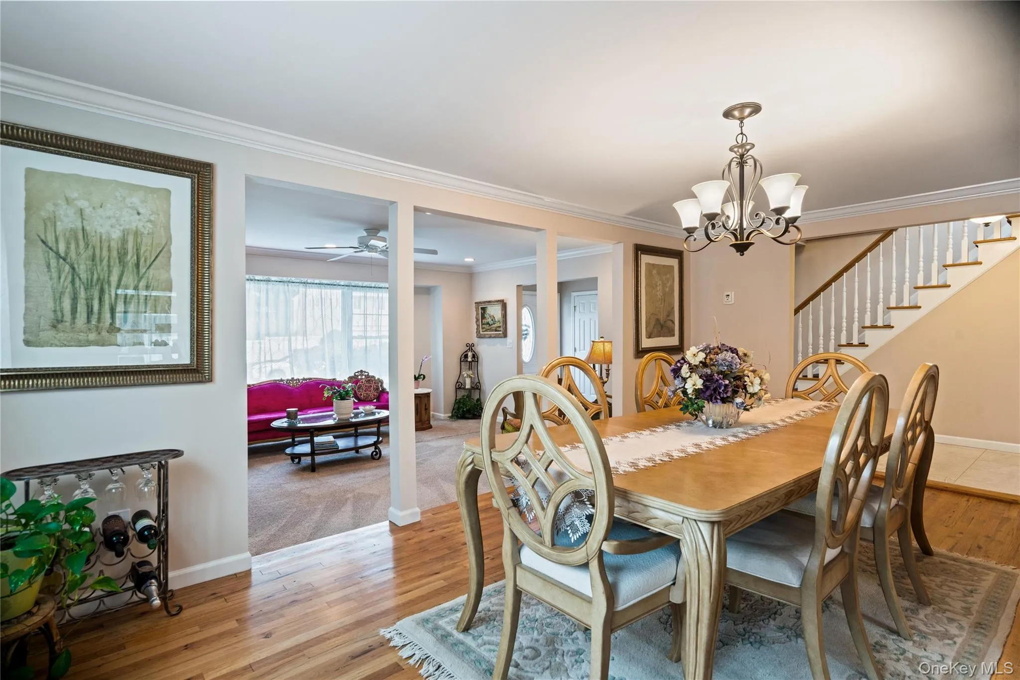 Hardwood flooring in a formal dining area featuring a chandelier Hardwood flooring in a formal dining area featuring a chandelier