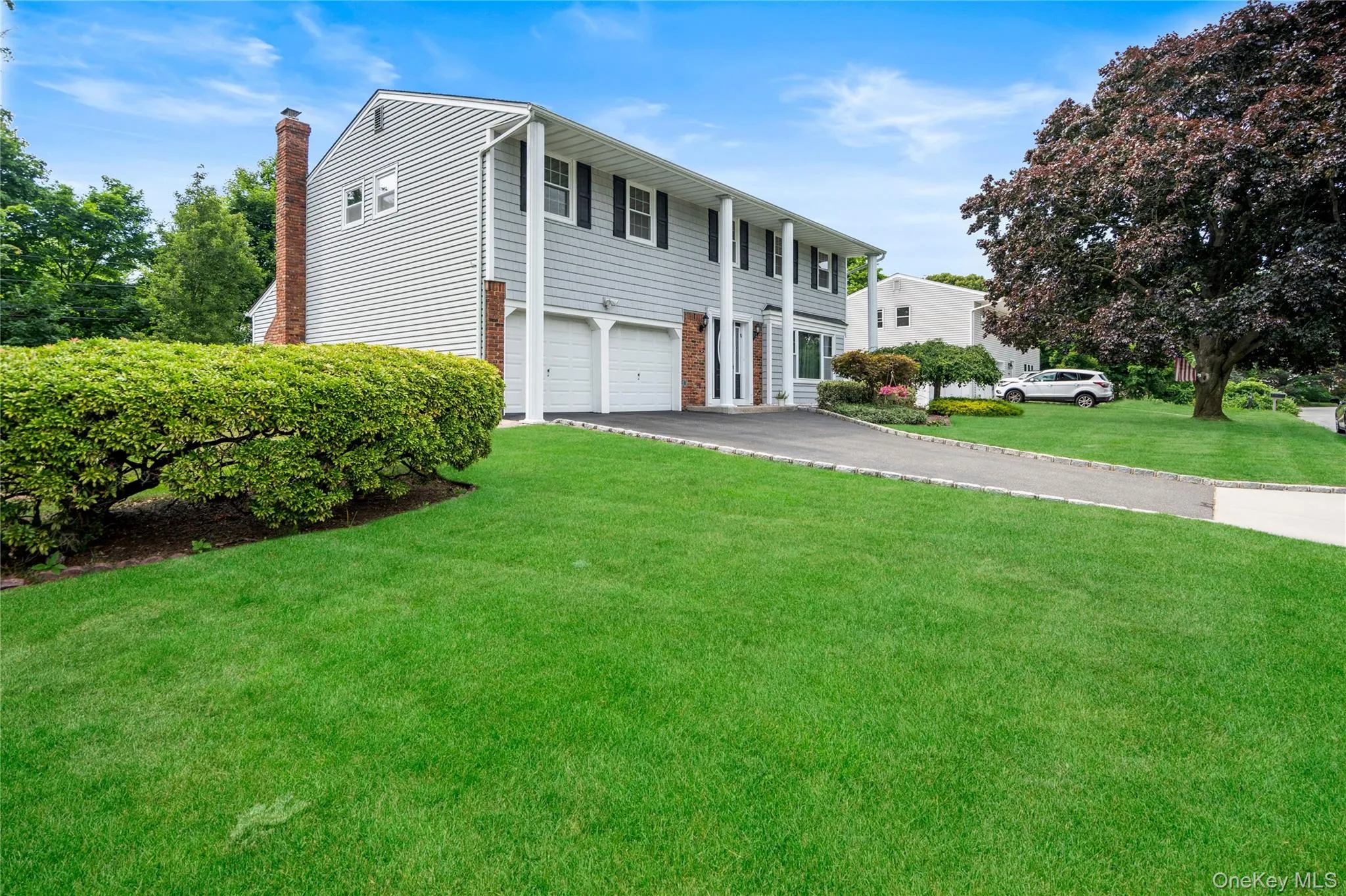 Split-level residence featuring gray siding and white trim Split-level residence featuring gray siding and white trim