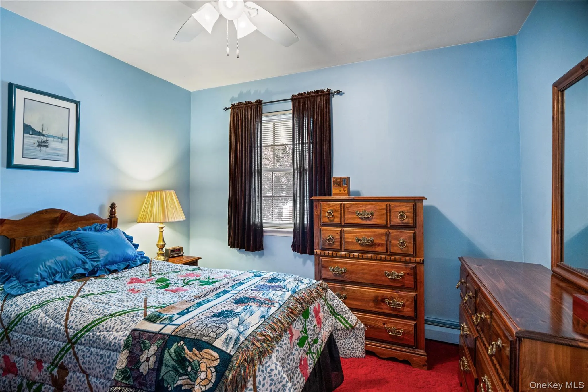 Bedroom with light blue walls and red carpeting Bedroom with light blue walls and red carpeting