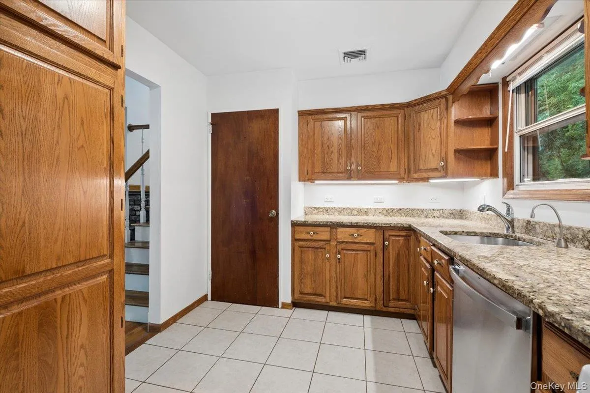 There's plenty of cabinets and counter space to satisfy any cook! The door leads down to the den and garage level. There's plenty of cabinets and counter space to satisfy any cook! The door leads down to the den and garage level.