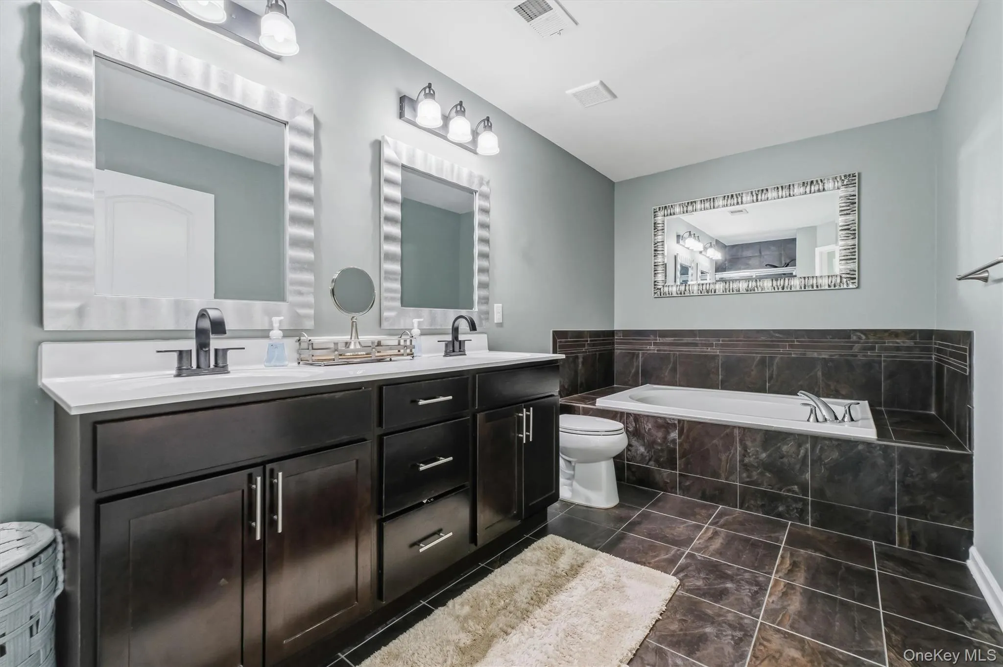 Primary Bathroom with double vanity and tub Primary Bathroom with double vanity and tub