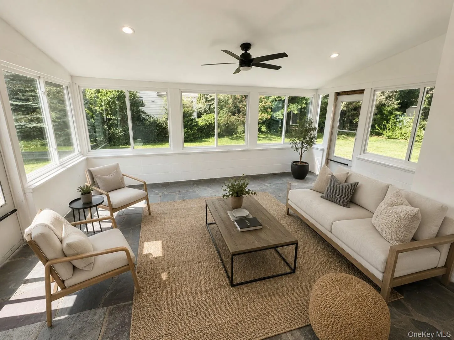 Bright and airy sunroom right off of the kitchen (virtually staged furniture). Bright and airy sunroom right off of the kitchen (virtually staged furniture).