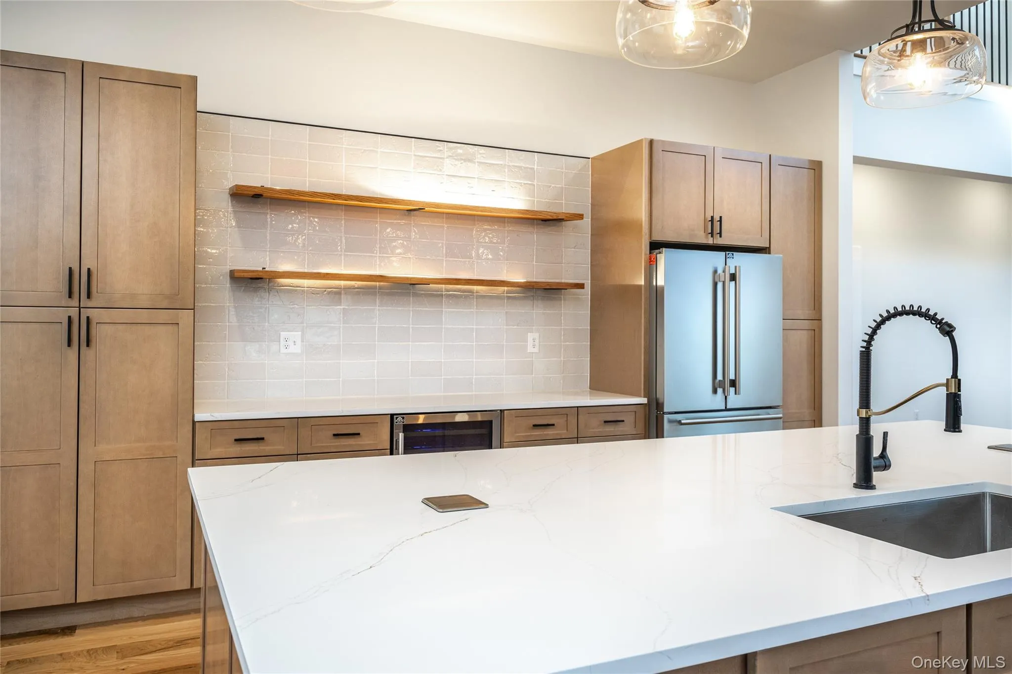 5 x 10 foot quartz island with automatic pop up electrical outlets, pantry lighted shelves, stainless steel refrigerator 5 x 10 foot quartz island with automatic pop up electrical outlets, pantry lighted shelves, stainless steel refrigerator