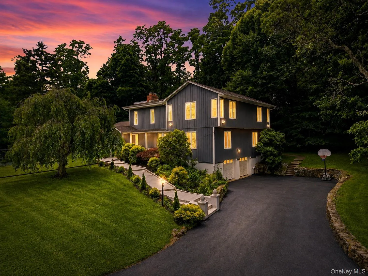 Two-story residence with dark siding and white trim Two-story residence with dark siding and white trim