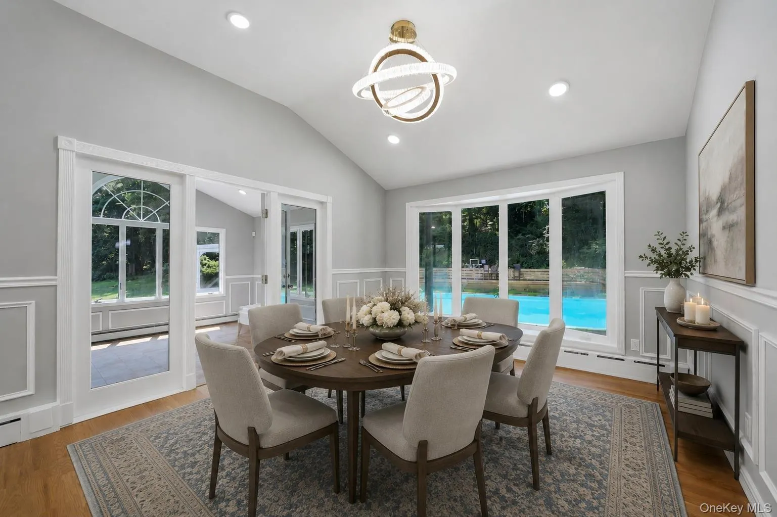 Open concept dining area featuring vaulted ceilings, recessed lighting, and wood-finish flooring Open concept dining area featuring vaulted ceilings, recessed lighting, and wood-finish flooring