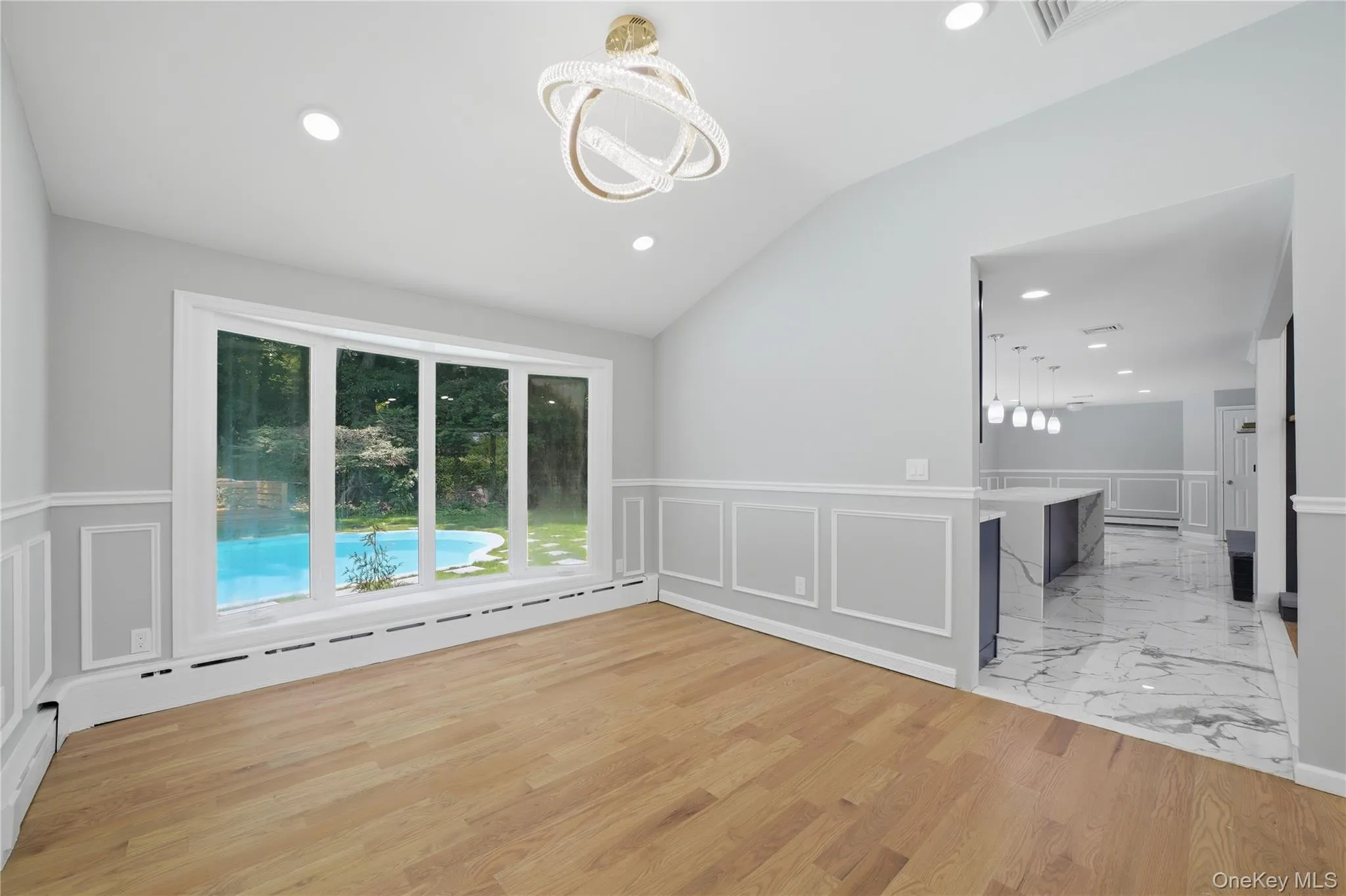 Open concept dining area featuring vaulted ceilings, recessed lighting, and wood-finish flooring Open concept dining area featuring vaulted ceilings, recessed lighting, and wood-finish flooring