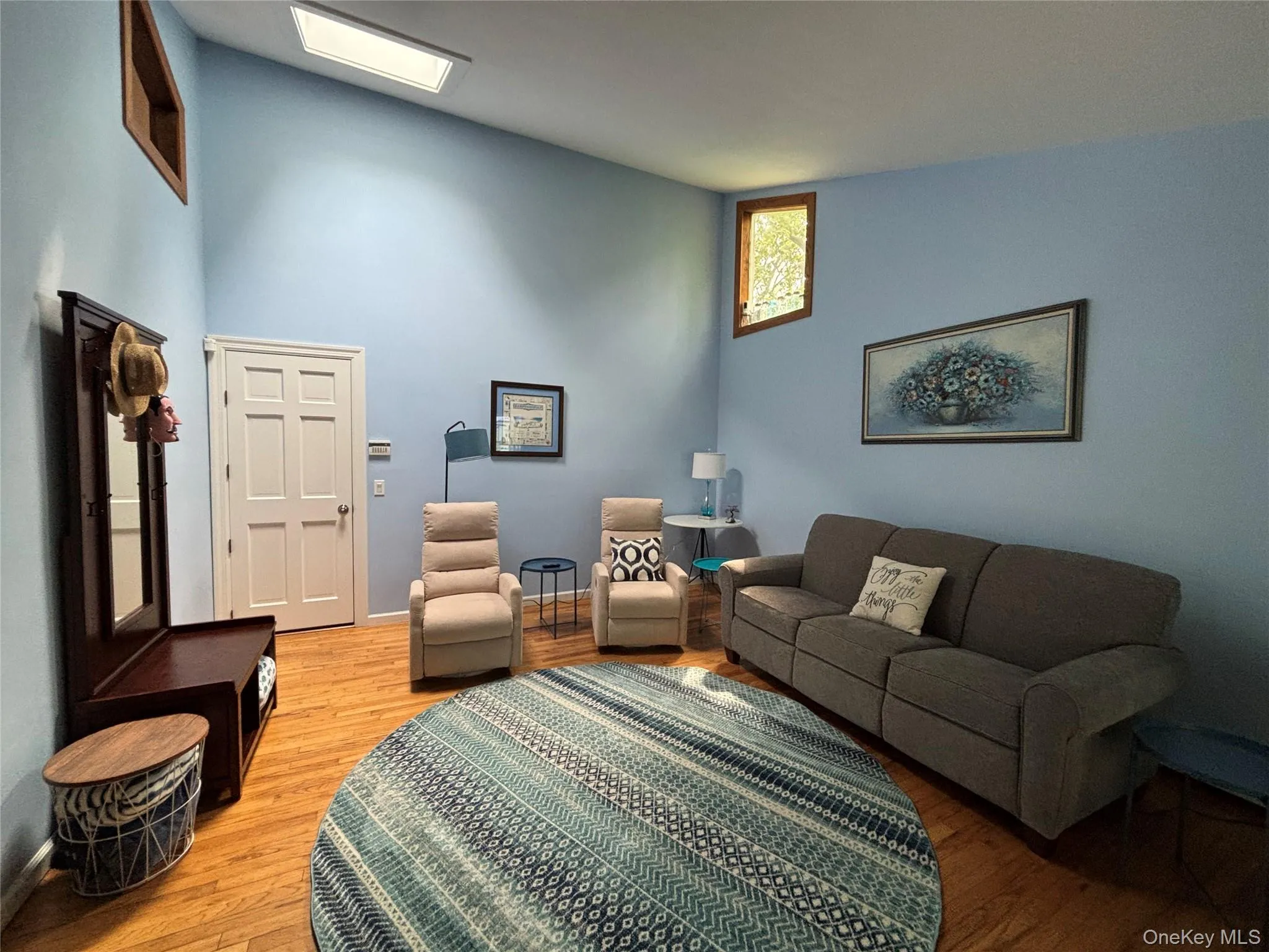 Vaulted ceiling room with natural wood-finish flooring, skylight for abundant light Vaulted ceiling room with natural wood-finish flooring, skylight for abundant light