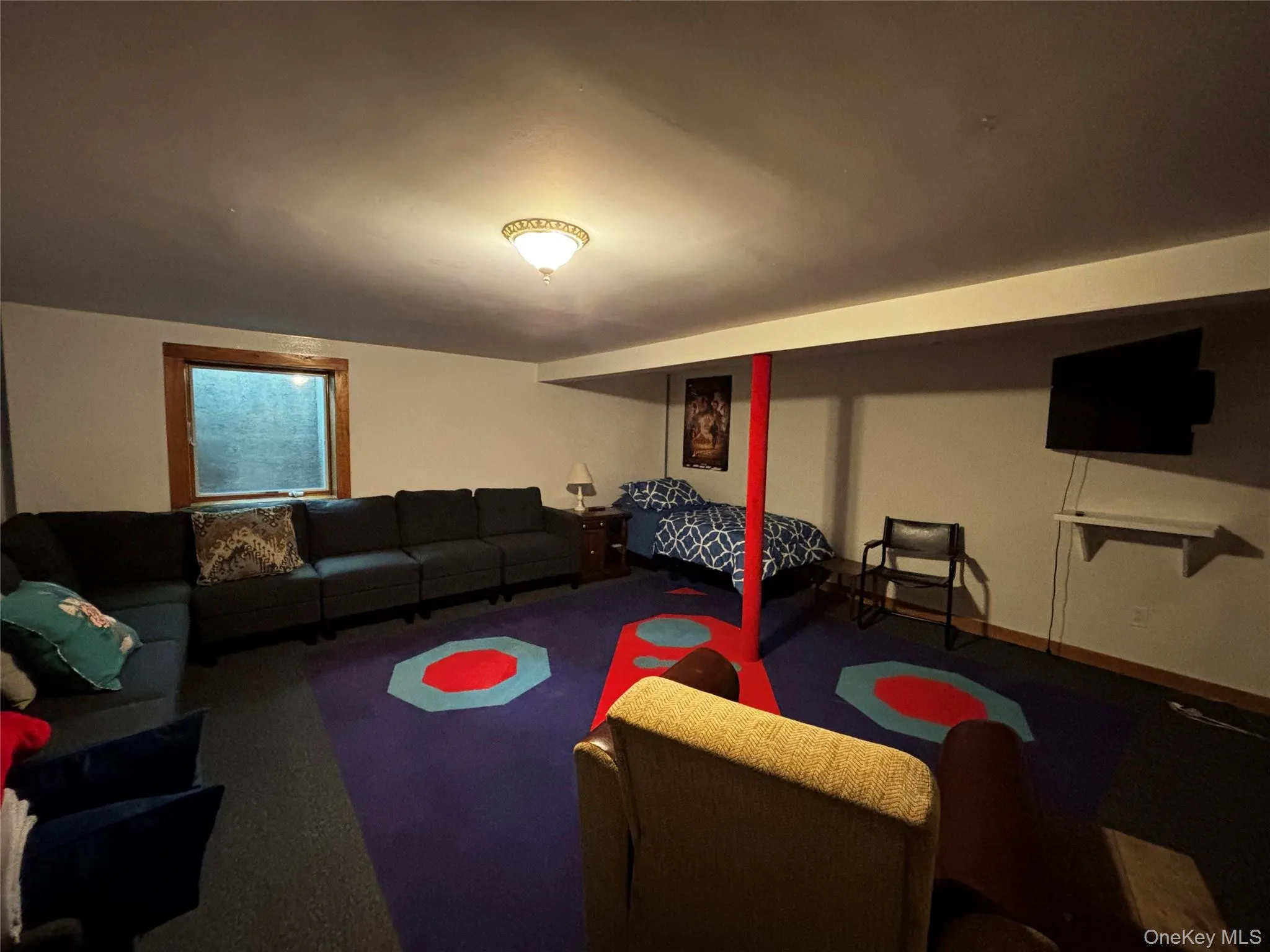 Playroom in basement has a single-bed, and sectional couch. Playroom in basement has a single-bed, and sectional couch.