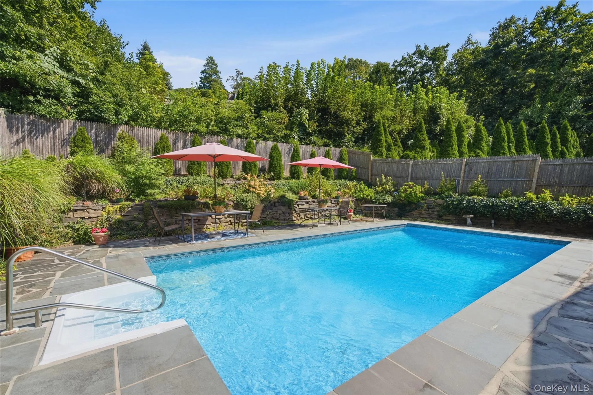 Inviting In ground pool flanked by stone walls and gardens Inviting In ground pool flanked by stone walls and gardens
