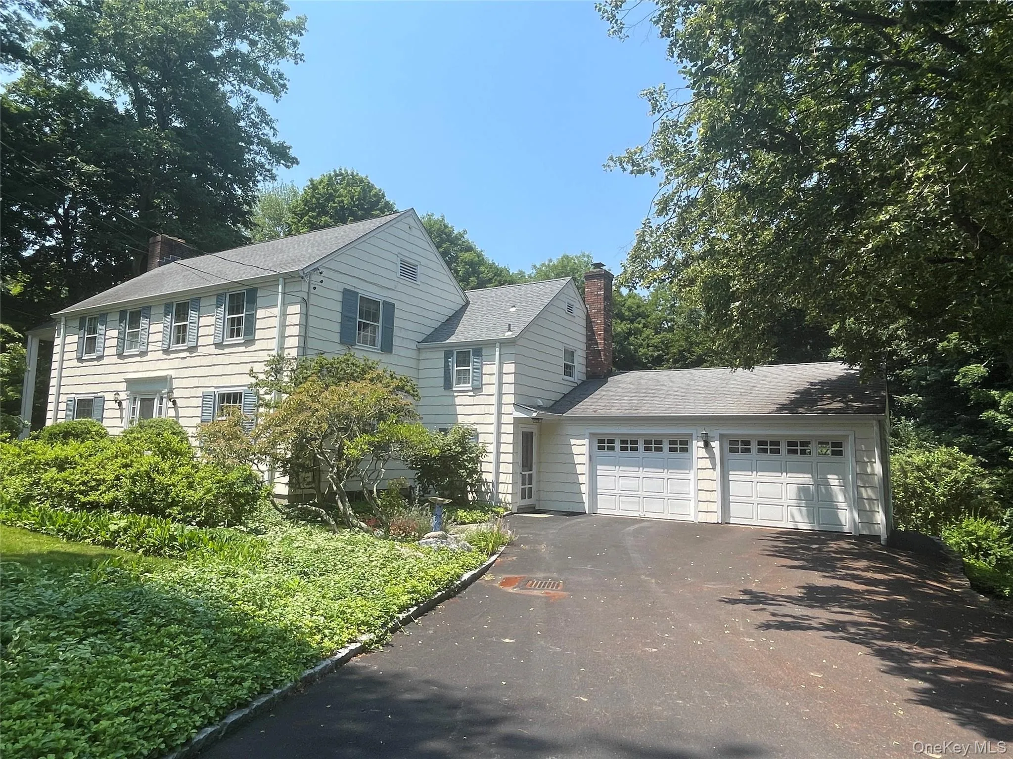 Flat driveway, charming curb appeal, expansion potential over main level garage Flat driveway, charming curb appeal, expansion potential over main level garage