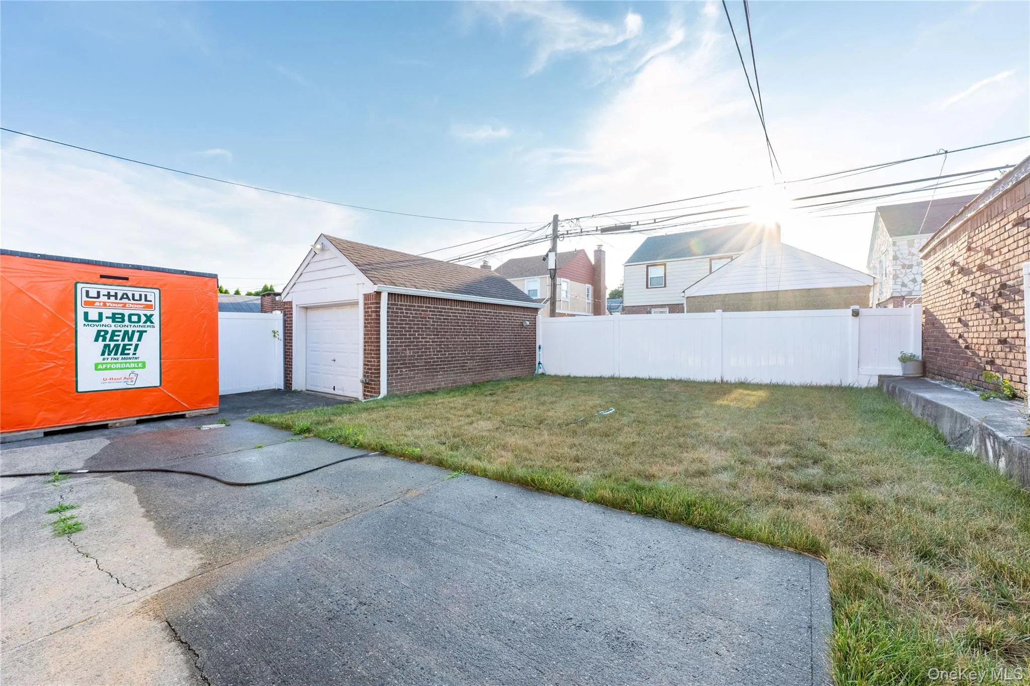 Back of house showing garage. Back of house showing garage.