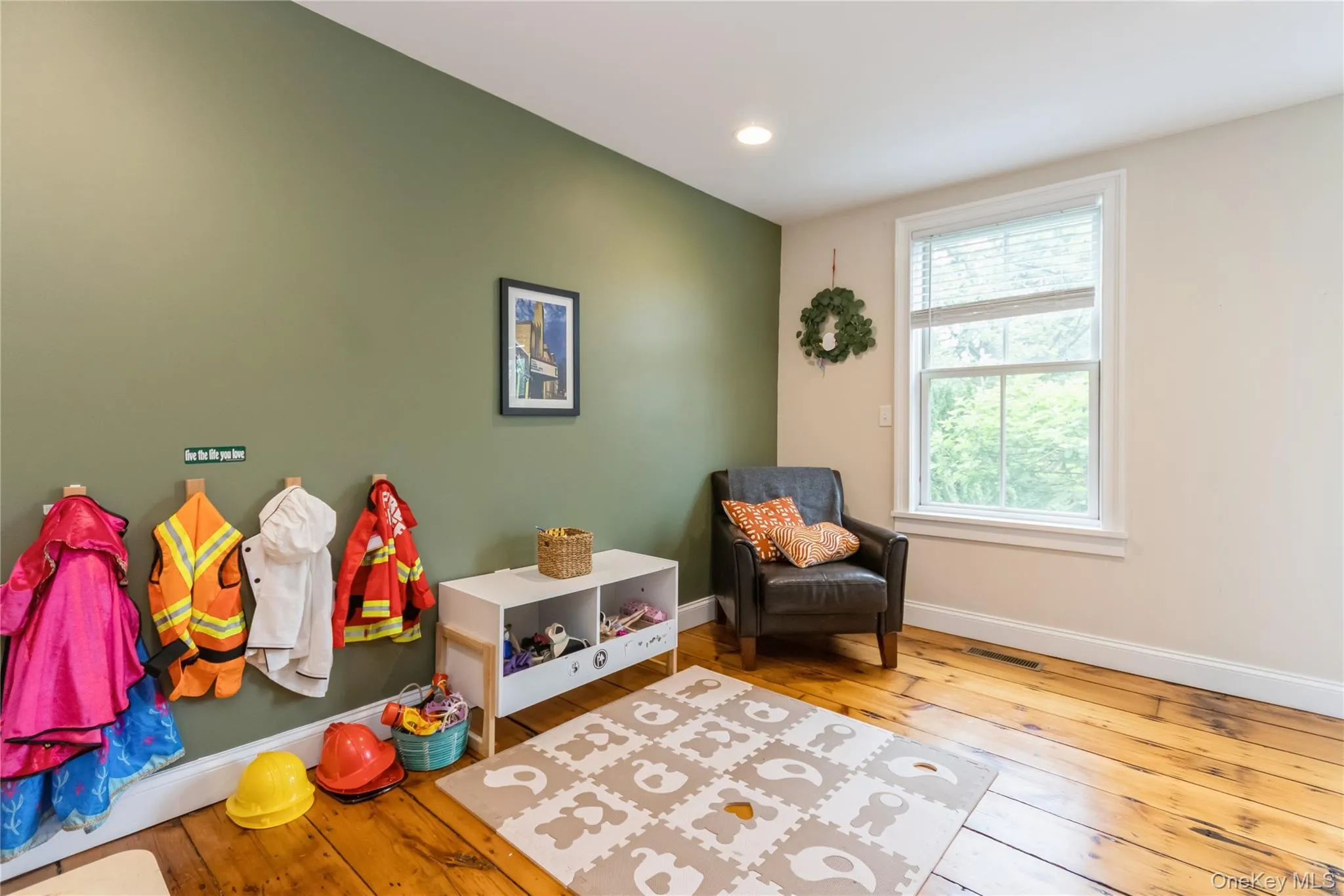 Living area featuring hardwood / wood-style floors and recessed lighting Living area featuring hardwood / wood-style floors and recessed lighting