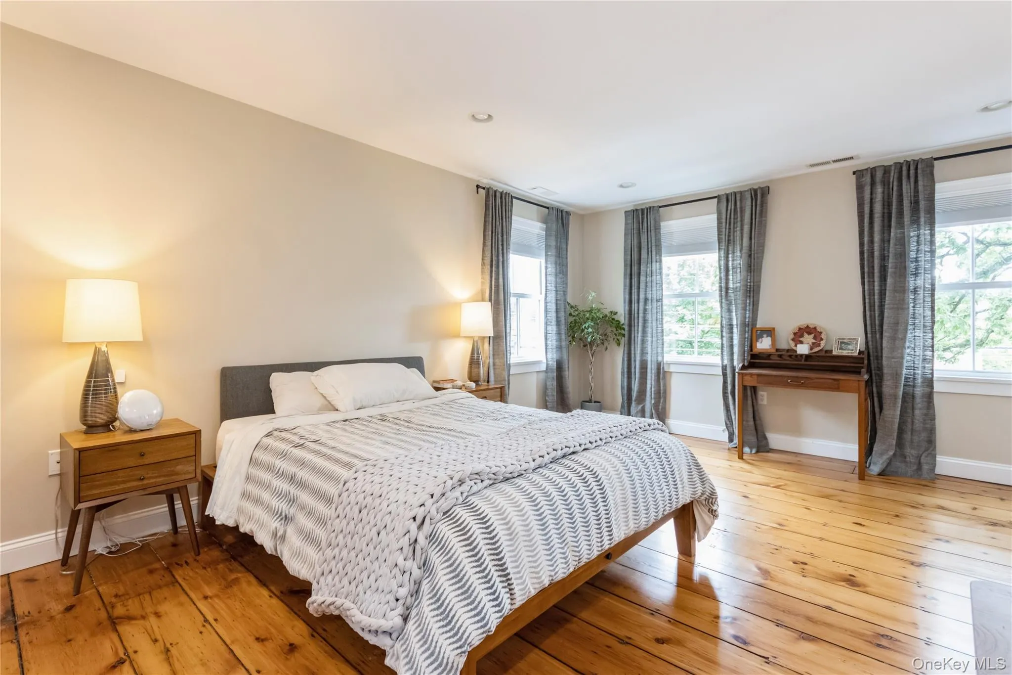 Bedroom with wood-type flooring and recessed lighting Bedroom with wood-type flooring and recessed lighting