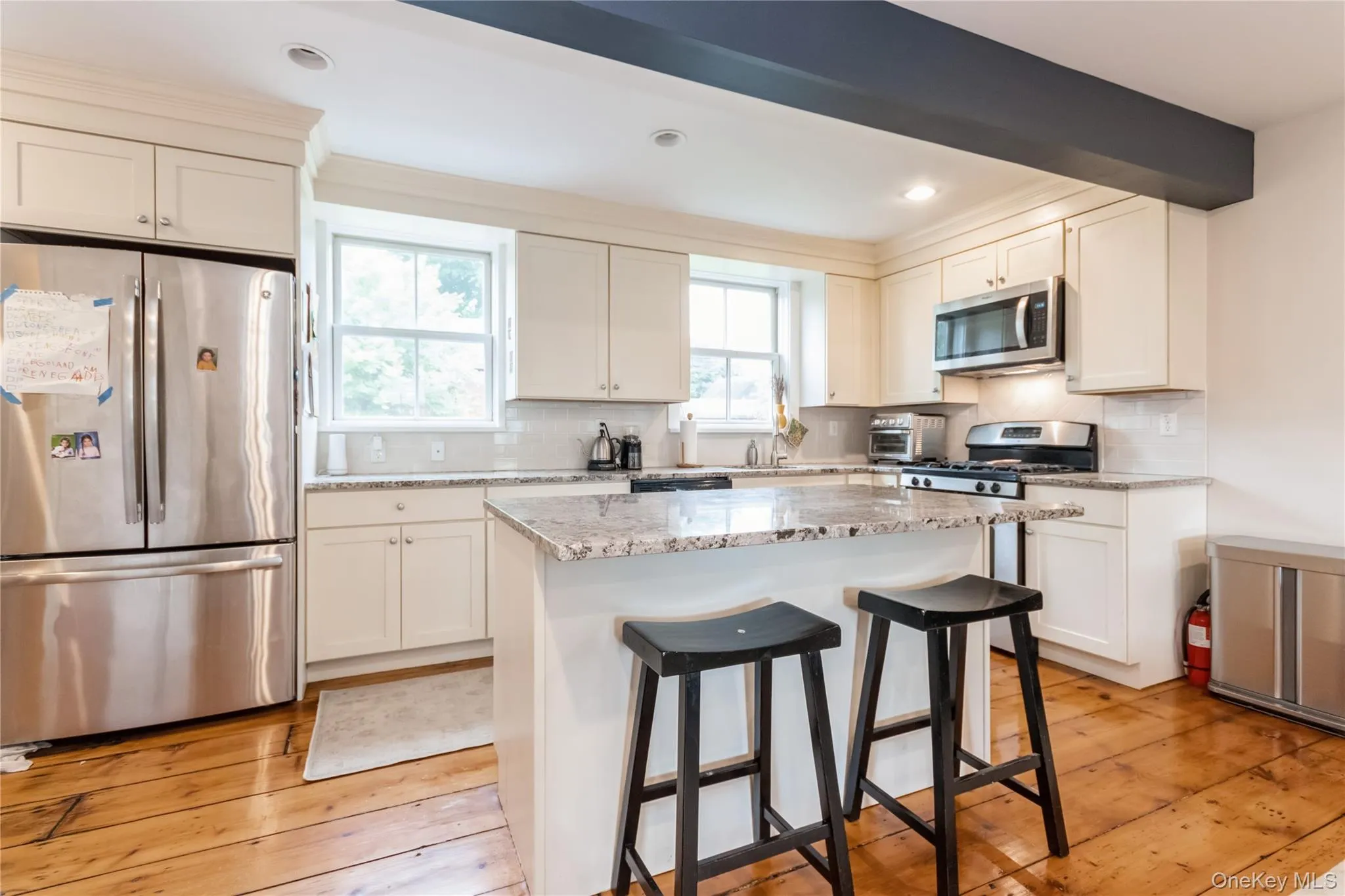Kitchen with stainless steel appliances, healthy amount of natural light, a breakfast bar area, light wood-style floors, and recessed lighting Kitchen with stainless steel appliances, healthy amount of natural light, a breakfast bar area, light wood-style floors, and recessed lighting