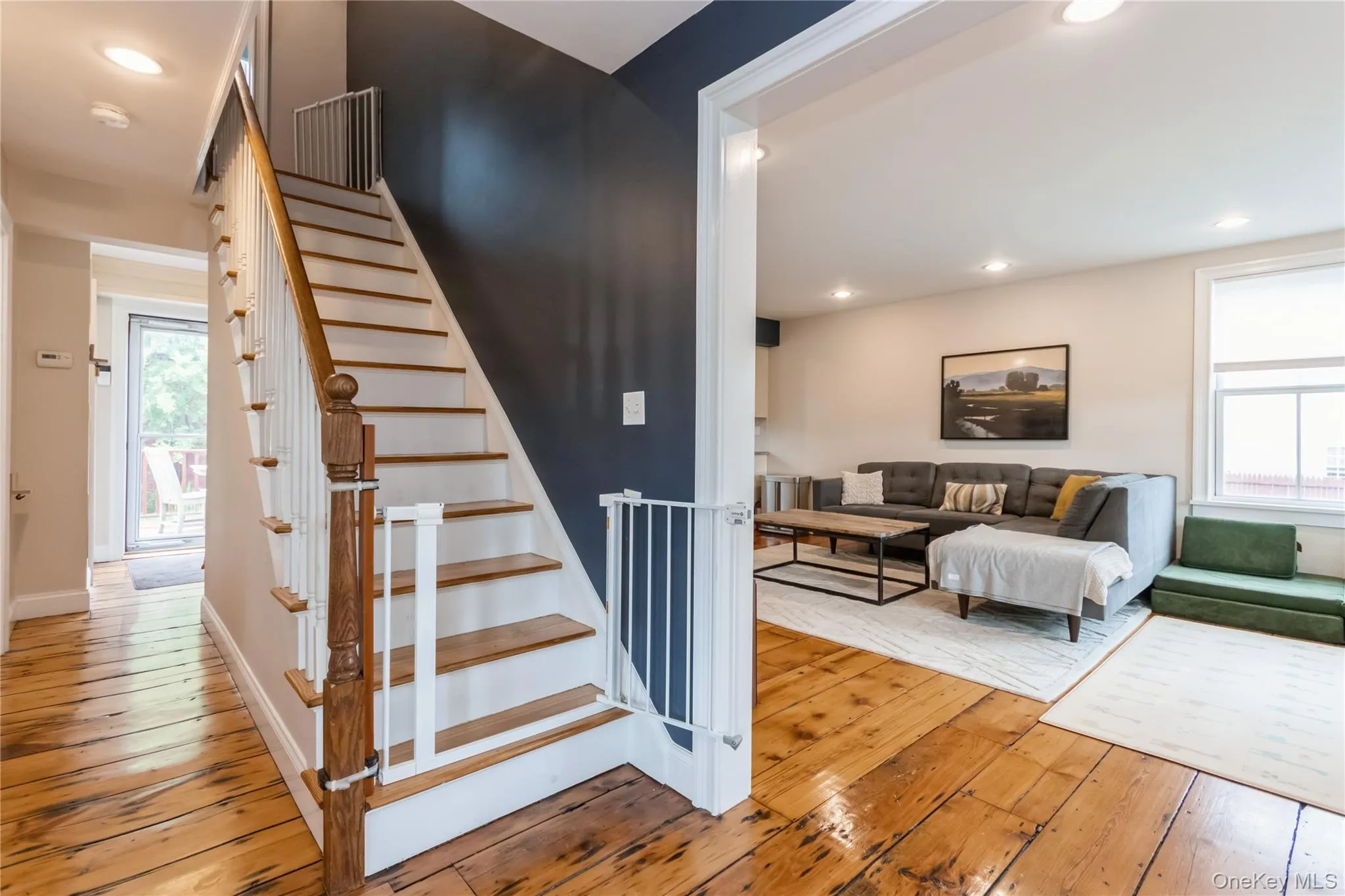 Stairs with hardwood / wood-style floors, plenty of natural light, and recessed lighting Stairs with hardwood / wood-style floors, plenty of natural light, and recessed lighting