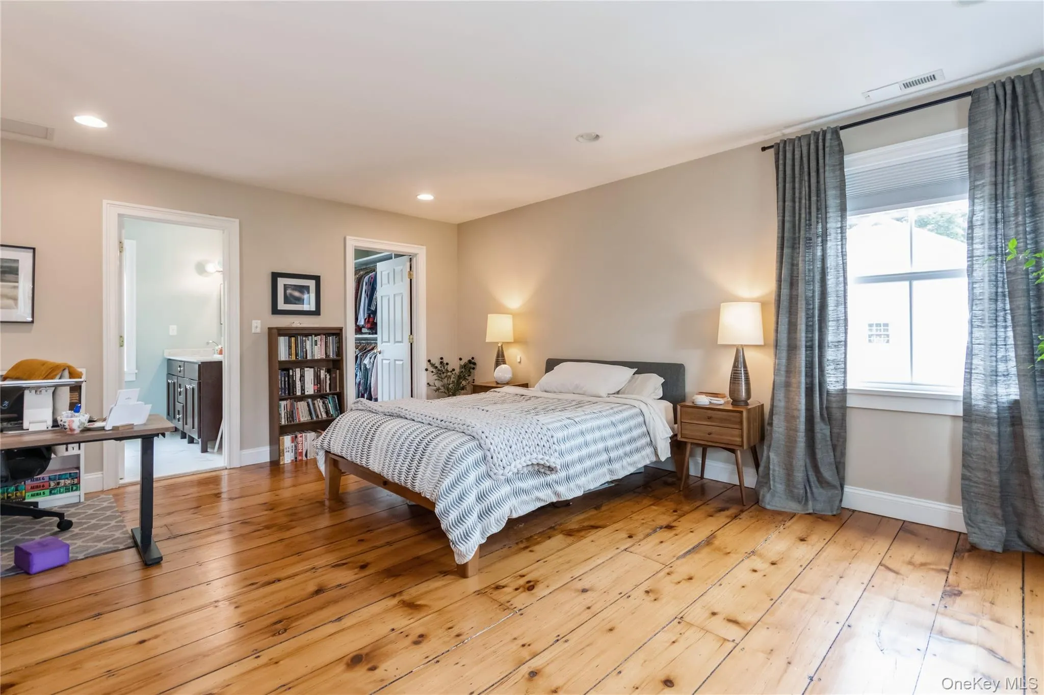 Bedroom featuring light wood-type flooring, recessed lighting, a spacious closet, and a closet Bedroom featuring light wood-type flooring, recessed lighting, a spacious closet, and a closet