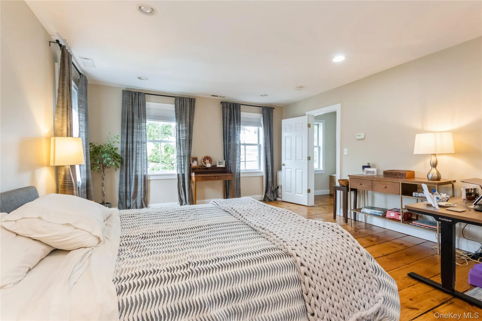 Bedroom featuring wood-type flooring and recessed lighting Bedroom featuring wood-type flooring and recessed lighting