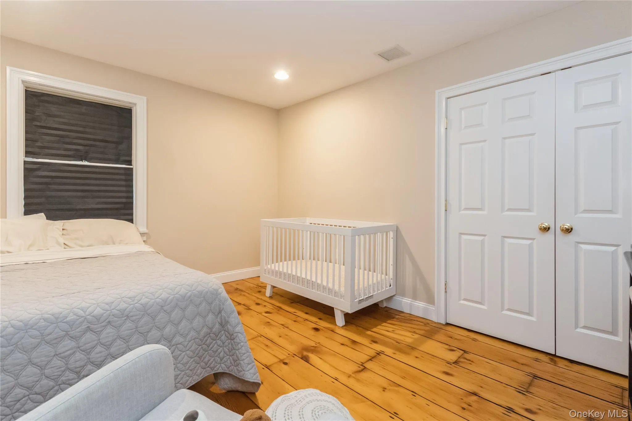Bedroom with light wood-style flooring and recessed lighting Bedroom with light wood-style flooring and recessed lighting