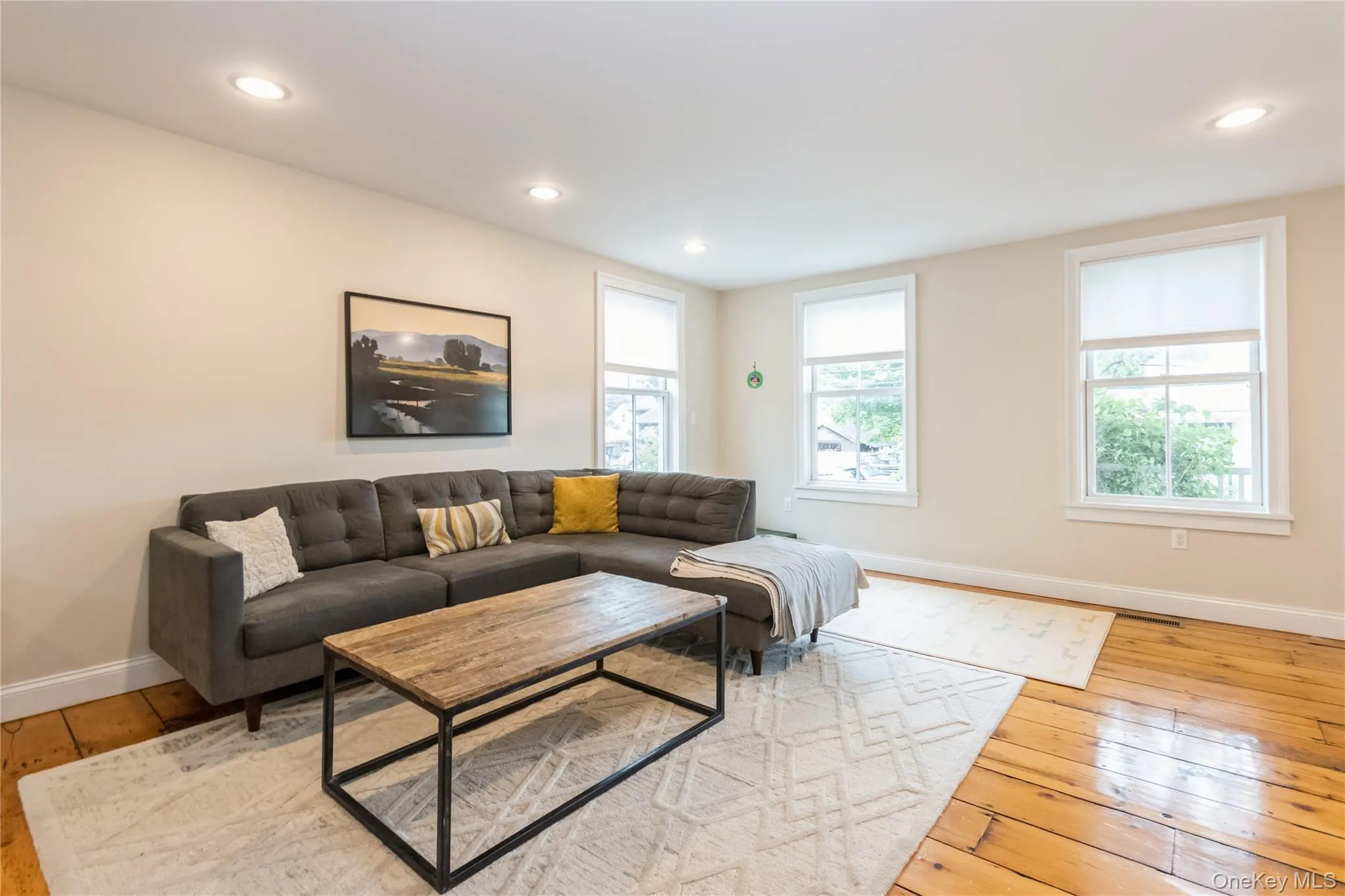 Living area with hardwood / wood-style flooring and recessed lighting Living area with hardwood / wood-style flooring and recessed lighting